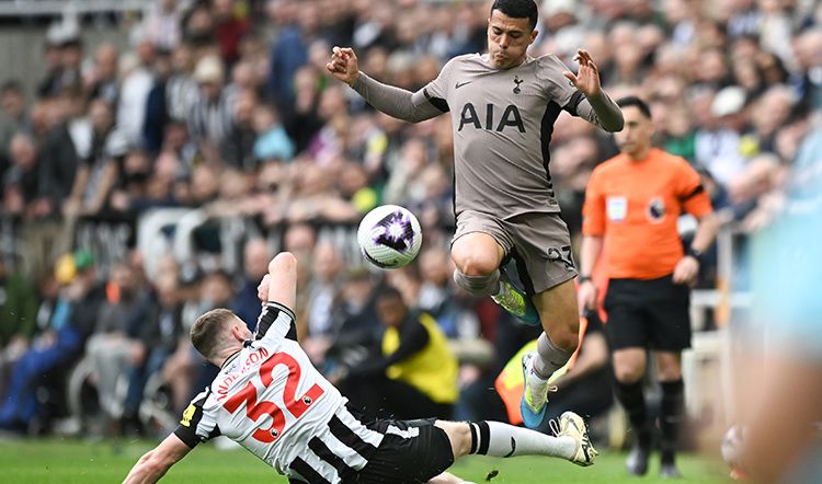 Elliott Anderson slides into Pedro Porro at St James' last season...